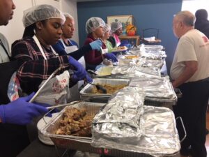 "Volunteers serving Thanksgiving meal" "Volunteers serving Thanksgiving meal"
