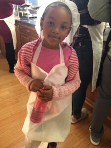 Young Volunteer helping to serve meals.
